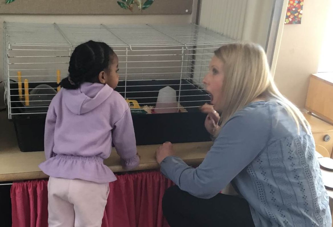 Adult and child looking in a cage